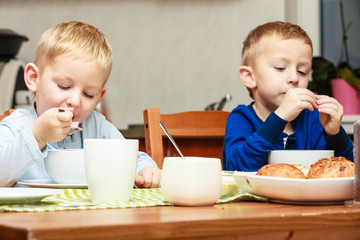 Boys kids children eating corn flakes breakfast meal