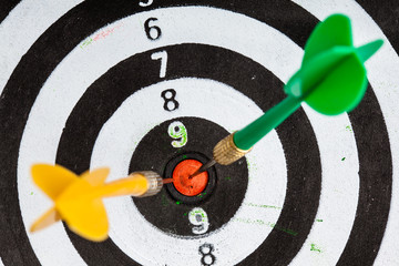 Bullseye. Black and white target with darts as sport background