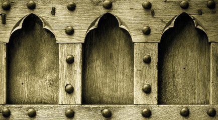 Architecture. Closeup of wooden door with rivets as background