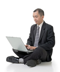 businessman using laptop on ground