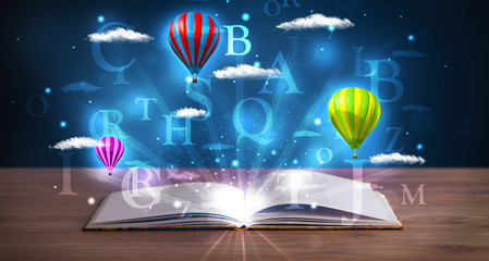 Open book with glowing fantasy abstract clouds and balloons
