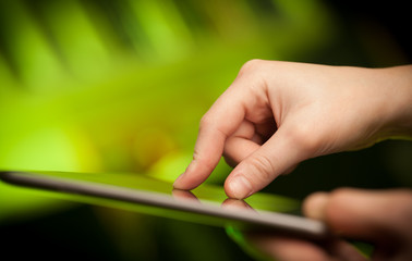 Finger pointing on tablet pc with empty space