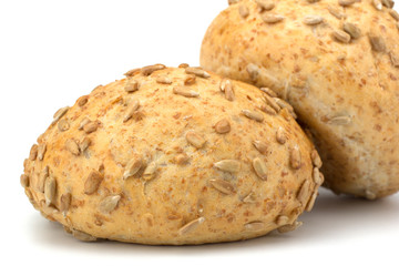 Round sandwich bun with sunflower seeds isolated on white backgr