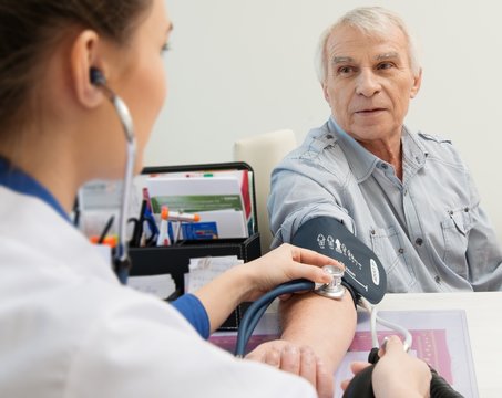 Senior Man Measuring Blood Pressure At Doctor's Office