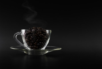 dark coffee beans on glass cup