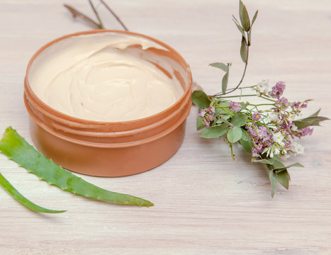 Jar With Body Cream On Wooden Table