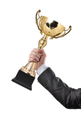 Businessman holding a champion golden trophy on white background