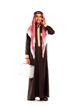 Young smiling arab with a aluminum case and cellphone isolated o