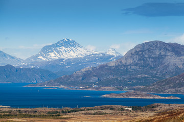 Coastal Norwegian mountain landscape with sea water in fjord