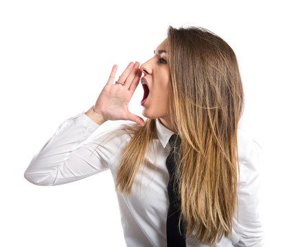 Young businesswoman shouting over isolated white background