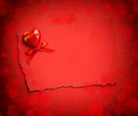 Decorative heart are on the sheet of red paper