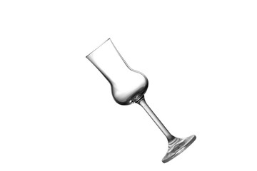 A tilted empty grappa glass isolated on white