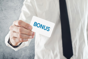 Businessman holding Bonus card.