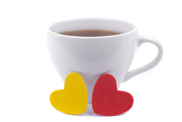 Cup of coffee and two hearts on a white background.