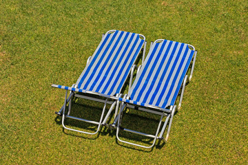 Couple of empty garden chairs on grass