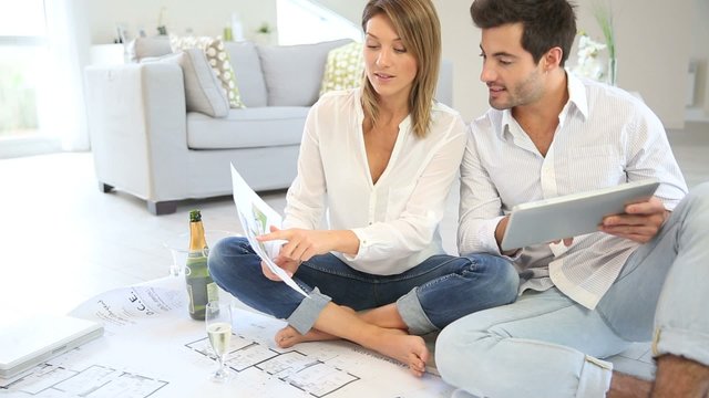 Couple at home celebrating new house purchase