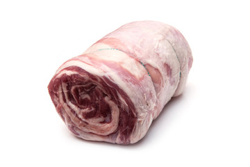 Rolled lamb breast joint,isolated on a white studio background.