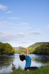 Fototapeta na wymiar Active woman practicing yoga outdoor.