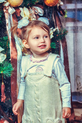 pretty little girl near the new year tree