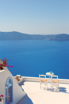 Fototapeta Rooftop Chairs on Santorini Greece