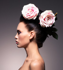 Fototapeta premium Profile portrait of a beautiful brunette woman with creative hai