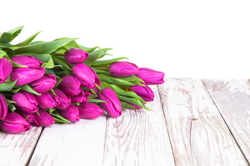 Purple tulips on wood background 