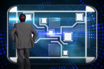 Composite image of businessman with hands on hips