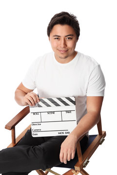 Attractive man holding a film slate