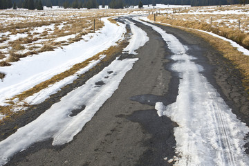 frozen winter asphalt road with snow
