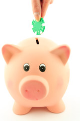A poker chip into a piggy bank