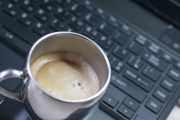 Coffee cup and keyboard