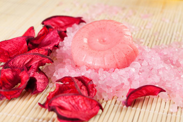 spa concept: handmade soaps, petals and sea salt
