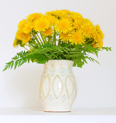 bouquet of dandelions in a jar
