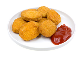 Chicken nuggets with ketchup on small plate