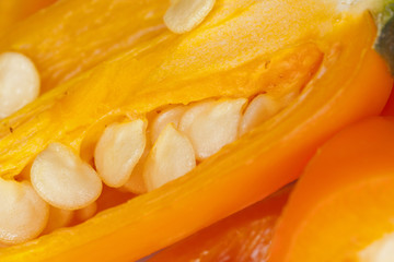 chili,close up surface of orange chili texture showing seeds.