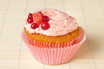cupcake with whipped cream and redcurrant
