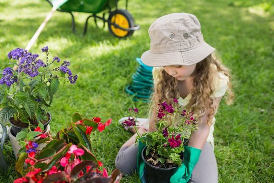 Little young girl engaged in gardening