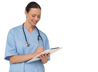 Smiling pretty nurse writing on clipboard