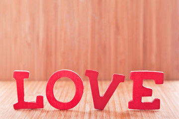 red wood alphabetic character on background