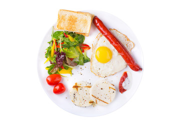 Fried egg and sausage on the plate with green salad and cheese