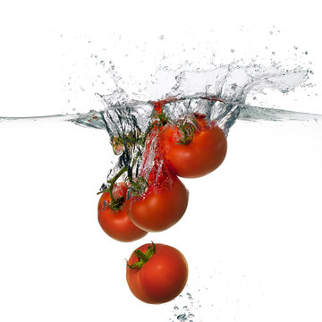 Fresh Red Tomatoes Splash in Water Isolated on White Background