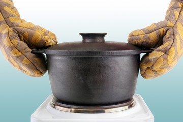 Oven mitts and hot cooking cauldron - 61044753