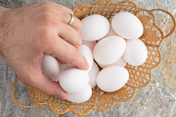 Man taking an egg from an Easter basket