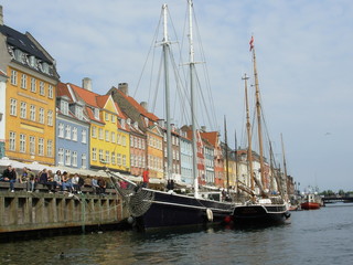 Fototapeta na wymiar Historic boats moored along Nyhavn Quayside, Copenhagen