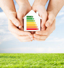 hands holding white paper house