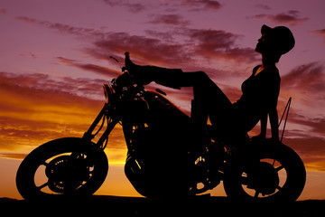 Plakat silhouette of woman sit back on motorcycle hat on