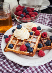 Belgian waffles with whipped cream and fresh berries
