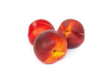 Three fresh nectarines on white
