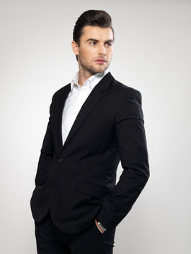 Fashion young businessman in black suit