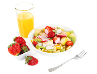 Useful fruit salad of fresh fruits and berries in bowl isolated